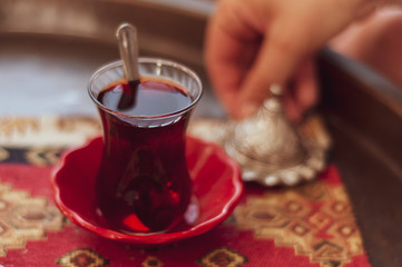 Authentic glasses with black hot tea on a table in a Turkish cafe. Lunch Tea Party.