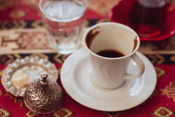 Authentic white cups with black coffee on the table in a Turkish cafe. Lunch coffee expresso.