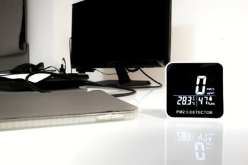 good indoor air quality. health interior environment no PM 2.5 dust founded. sensor detects no harmful particulate dust matter. detector on grass desk of an office building.