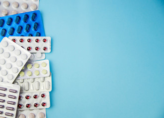 medicines, pills, vitamins in a package on a blue background. Space for copy.
