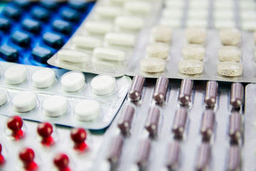 Pills, capsules with medicine, vitamins in a package, in a blister pack are on the table.