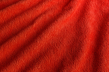 Textured fleecy fabric in red. Background.