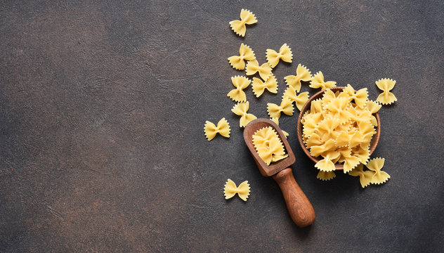 Pasta in a plate on a concrete dark background. Top view copy space.
