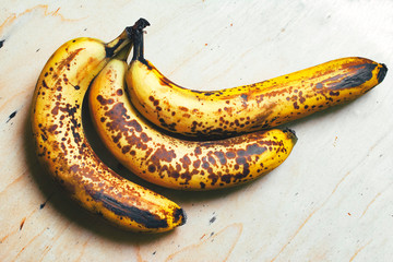 Ripe yellow bananas fruits, bunch of ripe bananas with dark spots on a white background with...