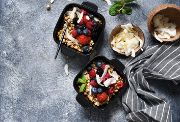 Granola with nuts, honey and berries for breakfast. Breakfast on the kitchen table, top view with place for text.