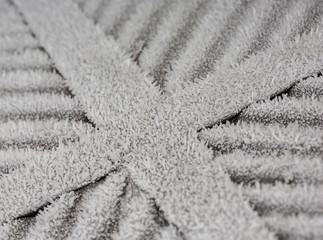 Frozen and crystalized cross symbol in a cold day.