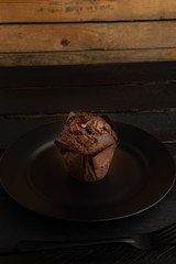 Chocolate cupcake on black wooden background