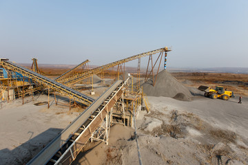 Industrial photography. Crushed stone conveyor for dump trucks in a quarry