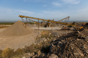 Industrial photography. Crushed stone conveyor for dump trucks in a quarry