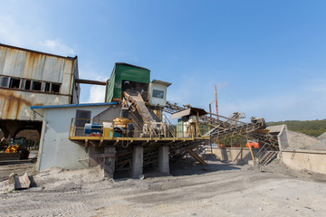 Fototapeta premium Industrial photography. Crushed stone conveyor for dump trucks in a quarry
