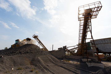 Fototapeta na wymiar Industrial photography. Crushed stone conveyor for dump trucks in a quarry