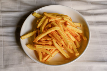 crispy french fries on white plate.