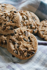 American chocolate cookies on blue cloth prepared for breakfast in the morning sunlight.