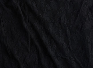 texture of crumpled black synthetic fabric guipure for sewing clothes