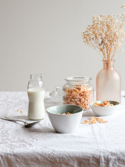 Simple breakfast table with milk and cornflakes