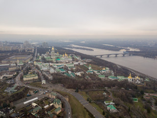 Fototapeta premium Aerial drone view. The territory of the monastery Kiev-Pechersk Lavra on a hill near the Dnieper River.