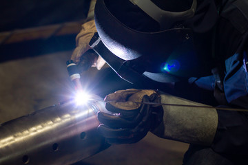 Metal workers use manual labor. Skilled welder. Factory workers making OT. Welder is welding the steel in the factory. welder Industrial automotive part in factory.