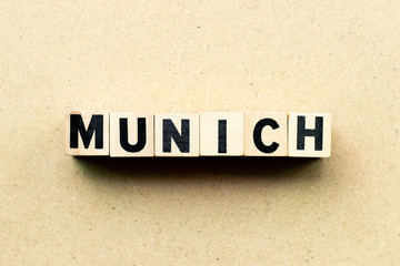 Letter block in word Munich on wood background