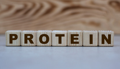 concept of the word protein on cubes on a beautiful wooden background