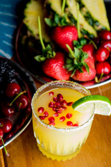 Frozen tropical cocktails. Traditional classic Hawaiian or tiki bar tropical drinks. Drinks w/  dark aged rum, blanco tequila, amaretto, garnished w/ limes pineapple cherries coconuts served frozen.