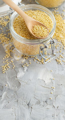 Raw dry hulled millet in a glass jar