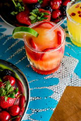 Frozen tropical cocktails. Traditional classic Hawaiian or tiki bar tropical drinks. Drinks w/  dark aged rum, blanco tequila, amaretto, garnished w/ limes pineapple cherries coconuts served frozen.