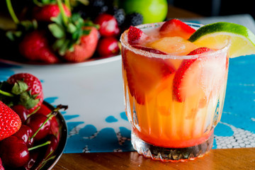 Frozen tropical cocktails. Traditional classic Hawaiian or tiki bar tropical drinks. Drinks w/  dark aged rum, blanco tequila, amaretto, garnished w/ limes pineapple cherries coconuts served frozen.