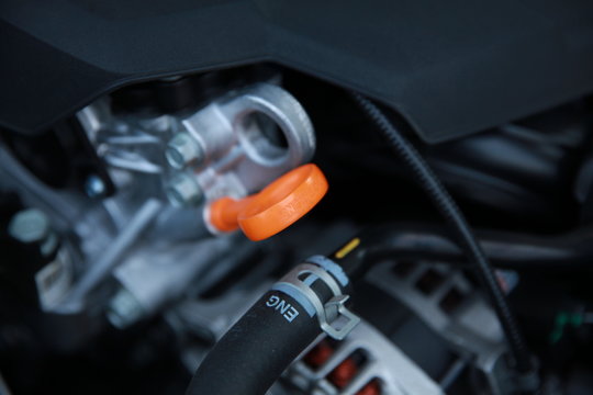 Close up image of car's orange dipstick. Checking engine oil.