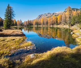 Fototapeta na wymiar Autumn alpine mountain lake near San Pellegrino Pass, Trentino, Dolomites Alps, Italy.