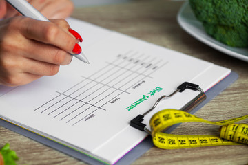 Nutritionist prepares a diet plan for an overweight woman