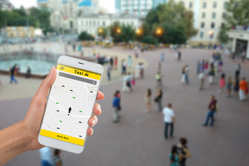 Online Booking Taxi app design - hand holding a smartphone, ordering a taxi