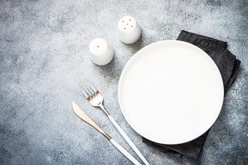 Cutlery set at stone kitchen table top view.