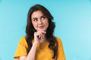 Dreaming pleased young pretty woman posing isolated