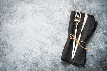 Cutlery set at stone kitchen table top view.