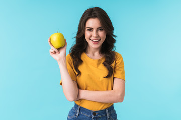 Happy young pretty woman holding apple.