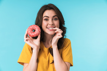 Optimistic positive young pretty woman holding donut.