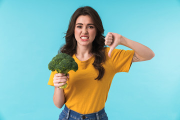 Displeased young beautiful woman showing thumbs down.