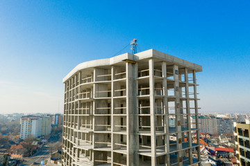 Aerial view of concrete frame of tall apartment building under construction in a city