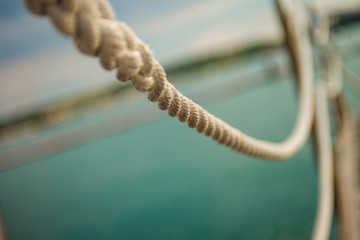 Obraz premium Close up of hanging rope at marina