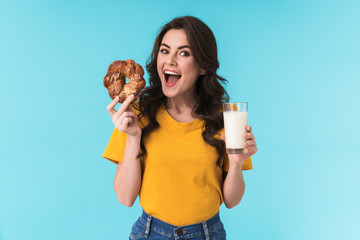 Woman holding milk and pastries.