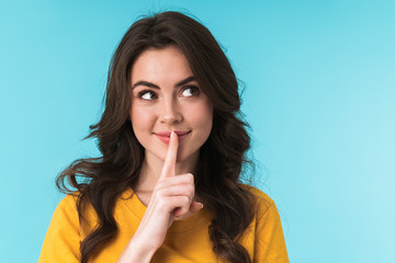 Woman posing isolated showing silence gesture.