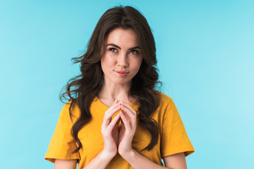 Cunning woman posing isolated over blue wall background.
