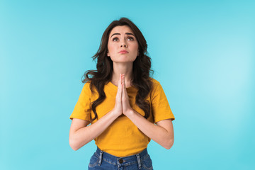 Nervous woman showing hopeful please pray gesture.