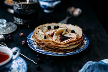 Pancakes with wild berries in a plate