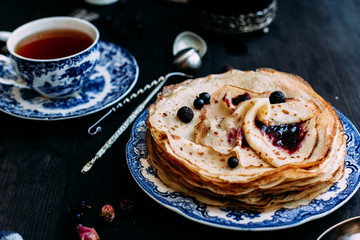 Pancakes with wild berries in a plate
