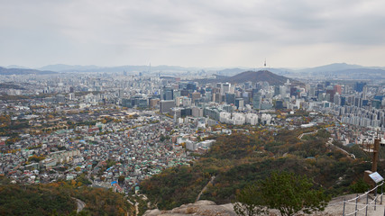 Aerial panorama of the Seoul with N Tower on the top of Namsan Mountain and downtown in South Korea from the top of Inwangsan mountain. 