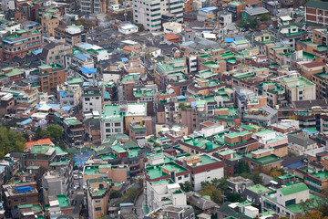 Aerial view to the apartments with a green roof in Seoul in South Korea from the top of Inwangsan mountain.