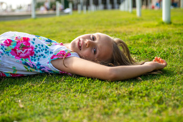 Medium close up of girl relaxing in the grass