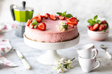 Cheesecake with fresh strawberries on a white table. Selective focus
