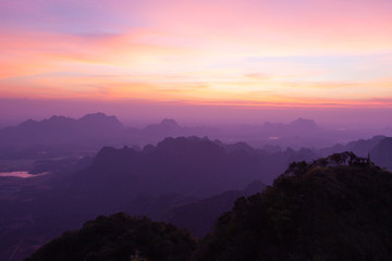 Sunset at Hpa-An mountains in Myanmar. Beautiful pinkish landscape with misty valleys.
